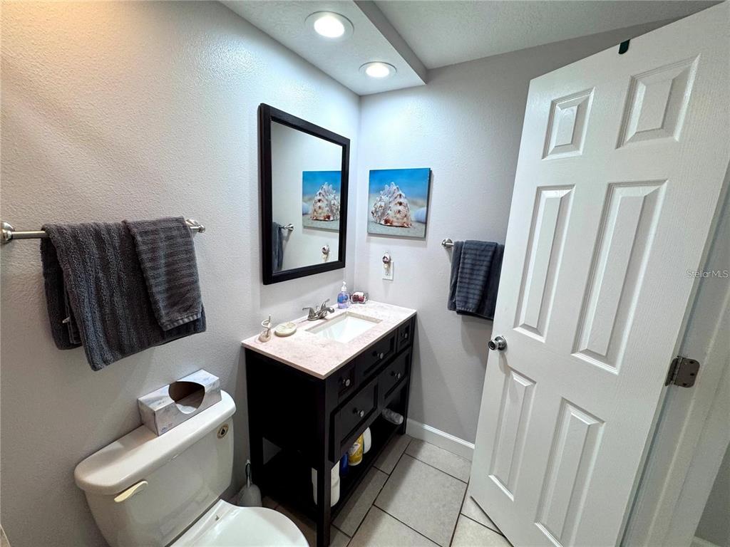 3473 Clark Road, Unit 171 Sarasota, FL 34231 - Photo 11 of 22 a bathroom with a toilet sink and mirror