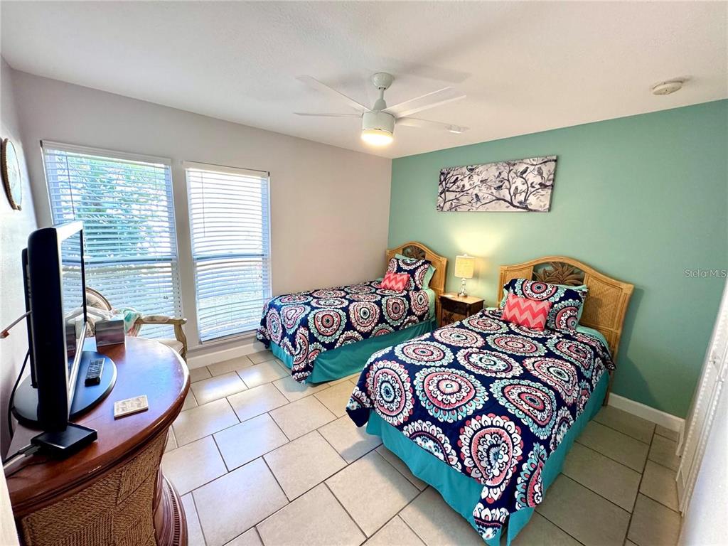 3473 Clark Road, Unit 171 Sarasota, FL 34231 - Photo 13 of 22 a bedroom with two beds and a window