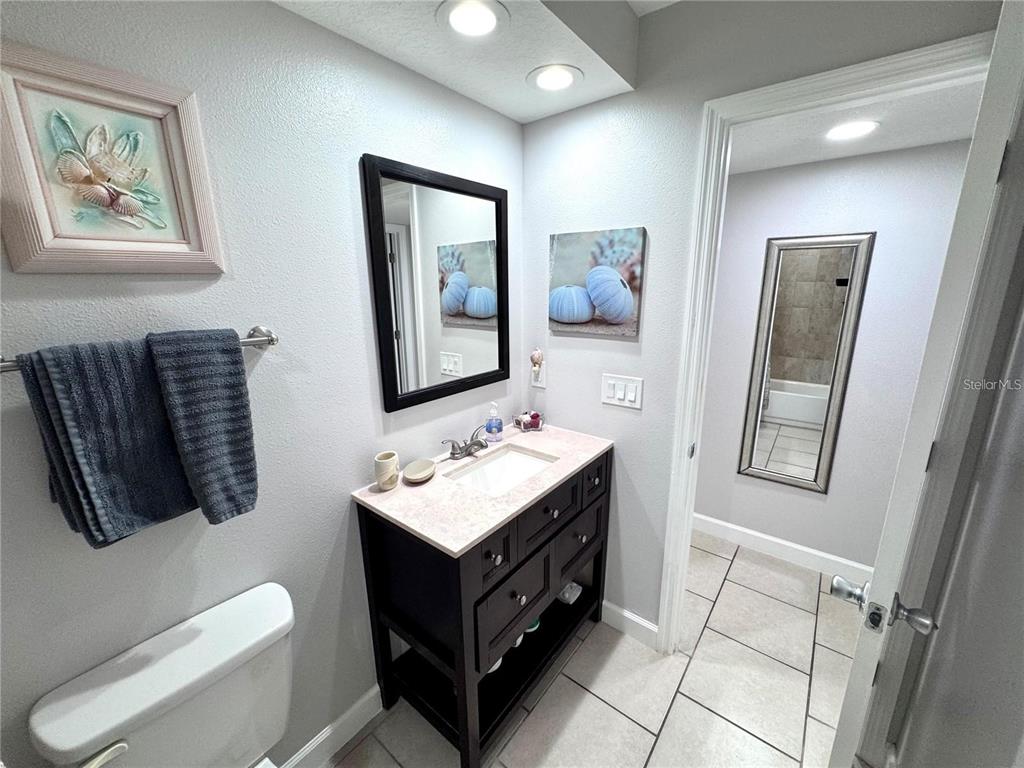 3473 Clark Road, Unit 171 Sarasota, FL 34231 - Photo 16 of 22 a bathroom with a toilet a sink and mirror