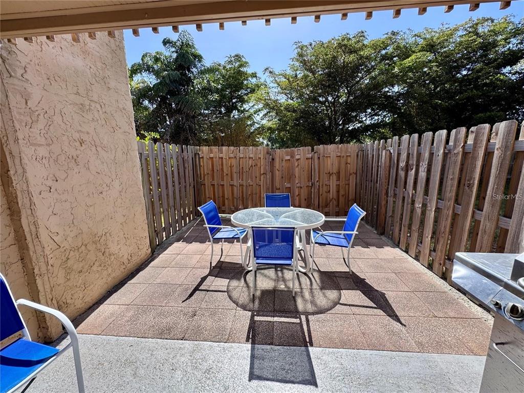 3473 Clark Road, Unit 171 Sarasota, FL 34231 - Photo 17 of 22 a backyard of a house with table and chairs