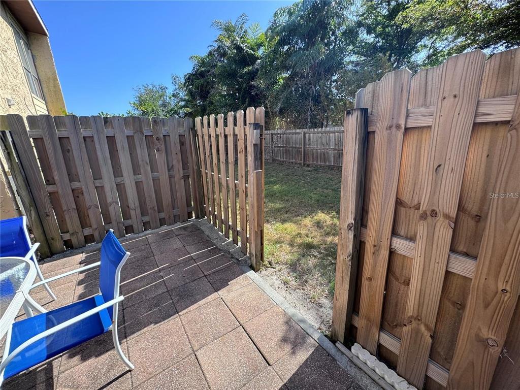 3473 Clark Road, Unit 171 Sarasota, FL 34231 - Photo 19 of 22 a backyard of a house with wooden floor