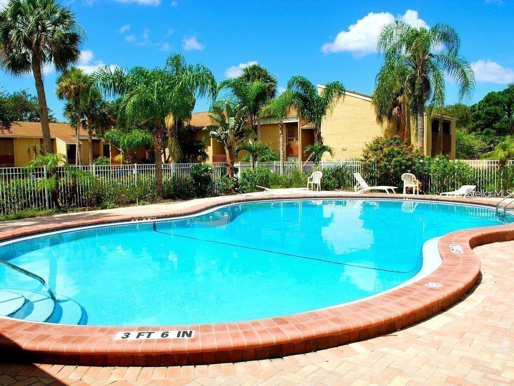 3473 Clark Road, Unit 171 Sarasota, FL 34231 - Photo 20 of 22 a view of a swimming pool with a yard