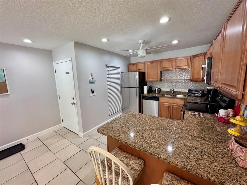 3473 Clark Road, Unit 171 Sarasota, FL 34231 - Photo 6 of 22 a kitchen with stainless steel appliances granite countertop a sink stove and refrigerator