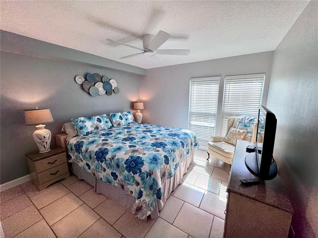 3473 Clark Road, Unit 171 Sarasota, FL 34231 - Photo 8 of 22 a bedroom with a bed and wooden floor