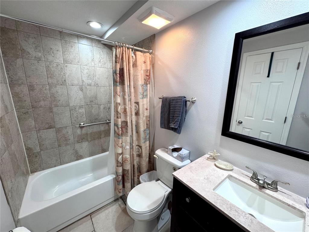 3473 Clark Road, Unit 171 Sarasota, FL 34231 - Photo 10 of 22 a bathroom with a granite countertop sink toilet and shower