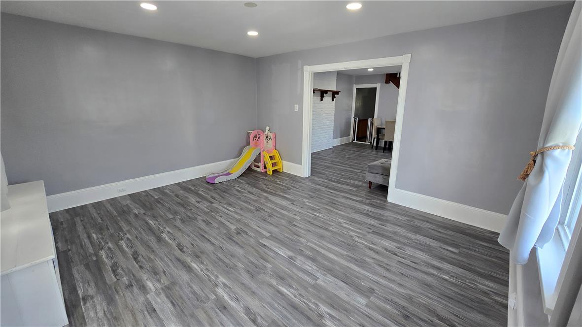 883 North Locust Street Hazleton, PA 18201 - Photo 10 of 83 Well-lit living area with durable plank flooring, ideal for a flexible layout.