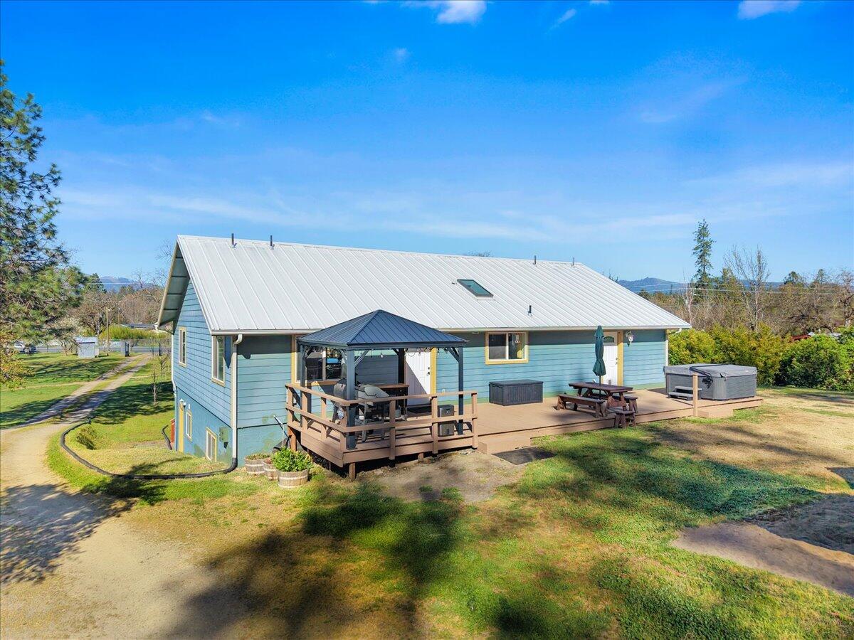 649 Pleasant Valley Road Merlin, OR 97532 - Photo 52 of 57 a backyard of a house with table and chairs