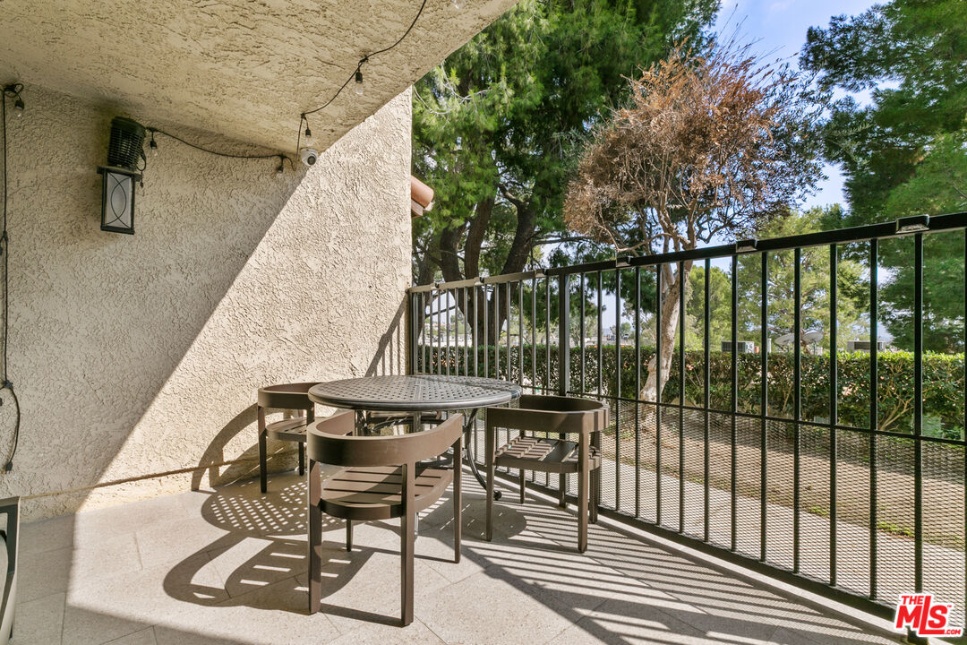 9772 Vía Roma Burbank, CA 91504 - Photo 16 of 44 a balcony with table and chairs