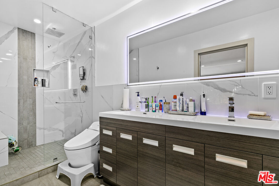 9772 Vía Roma Burbank, CA 91504 - Photo 21 of 44 a bathroom with a sink a toilet and a mirror