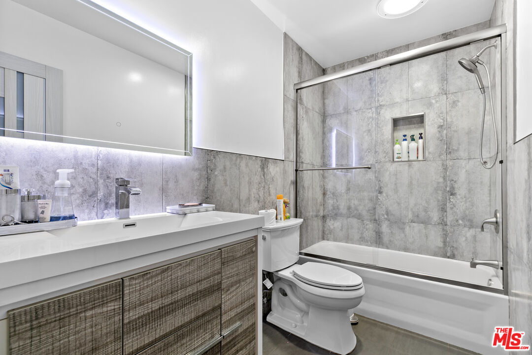 9772 Vía Roma Burbank, CA 91504 - Photo 25 of 44 a bathroom with a sink a toilet and shower