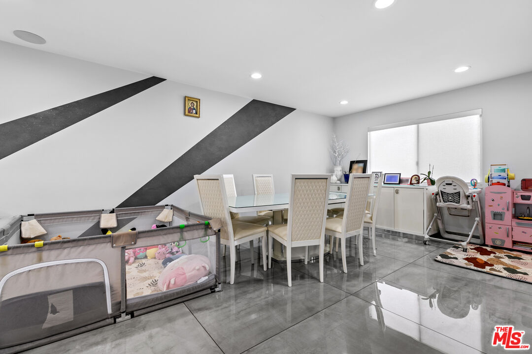 9772 Vía Roma Burbank, CA 91504 - Photo 9 of 44 a room with stainless steel appliances kitchen island granite countertop lots of clutter and chairs