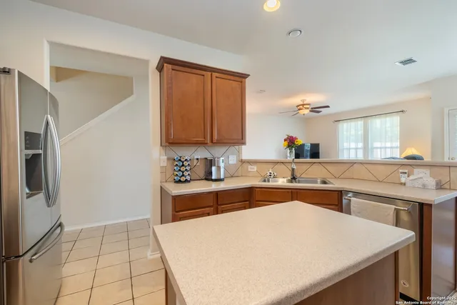 a kitchen with a sink a stove and cabinets