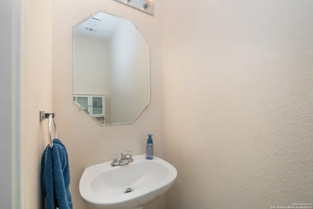 a bathroom with a sink and a mirror
