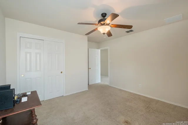 a living room with furniture a rug a large window and a flat screen tv