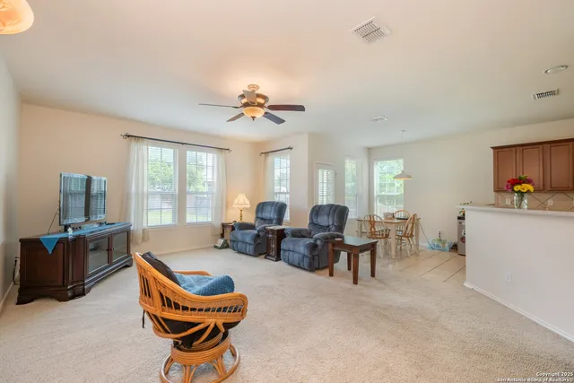 a living room with furniture windows and a flat screen tv