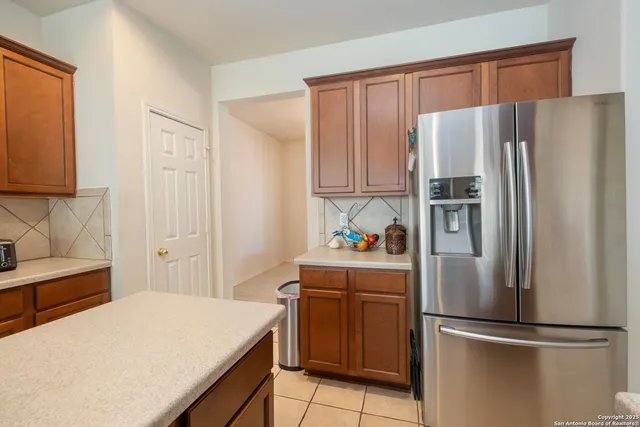 a kitchen with stainless steel appliances a refrigerator and a stove