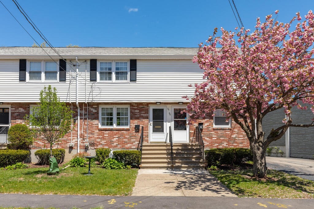 a front view of a house with a yard