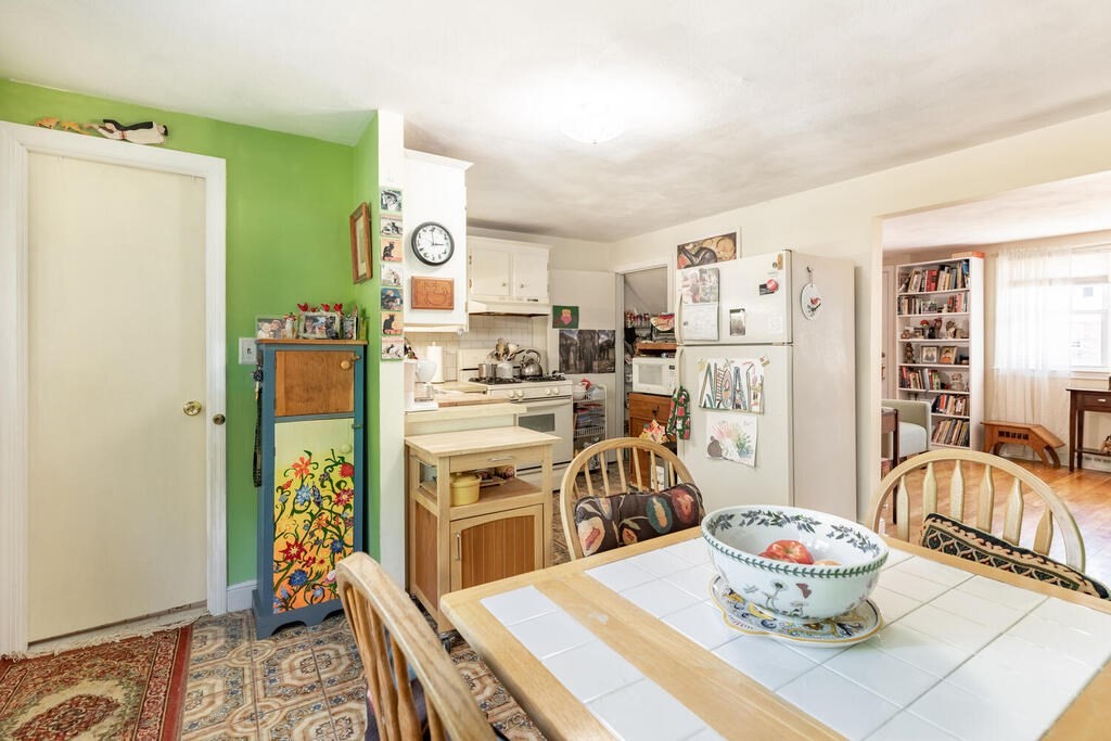 84 Lancaster Road, Unit 84 Dedham, MA 02026 - Photo 13 of 23 a kitchen with stainless steel appliances kitchen island granite countertop a refrigerator and a stove