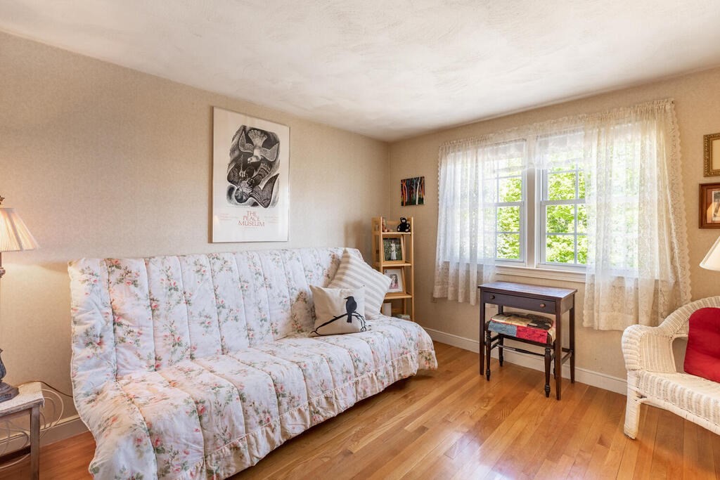 84 Lancaster Road, Unit 84 Dedham, MA 02026 - Photo 15 of 23 a bedroom with a bed and wooden floor