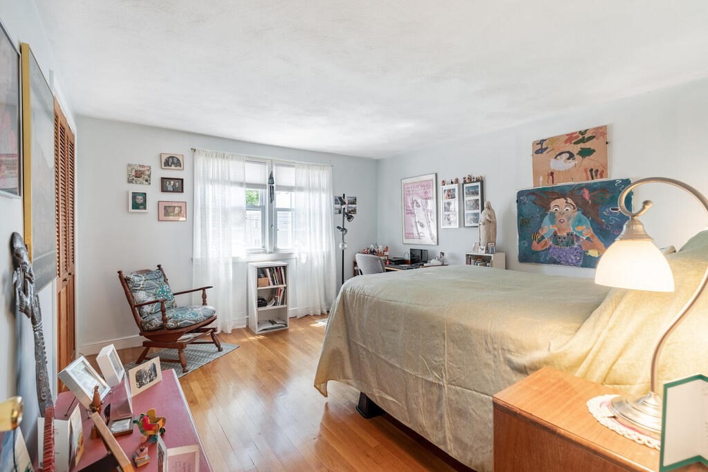 84 Lancaster Road, Unit 84 Dedham, MA 02026 - Photo 18 of 23 a bedroom with a bed and wooden floor