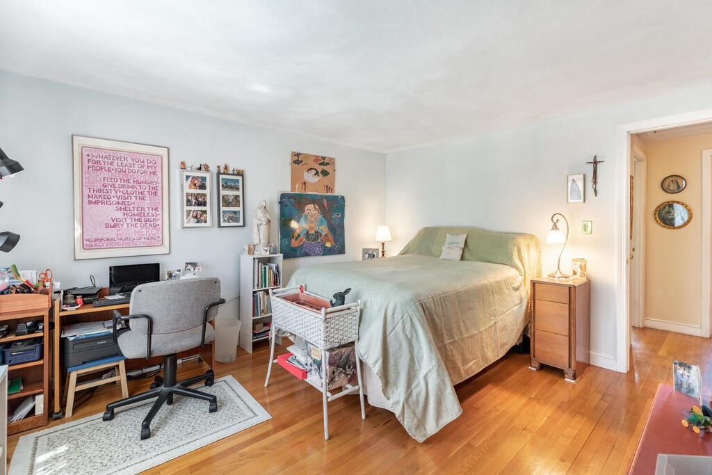 84 Lancaster Road, Unit 84 Dedham, MA 02026 - Photo 19 of 23 a bedroom with a bed and a chair