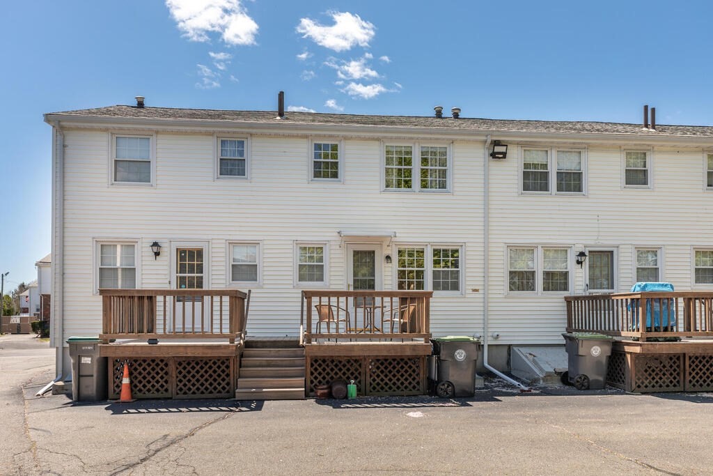 84 Lancaster Road, Unit 84 Dedham, MA 02026 - Photo 21 of 23 a front view of a house with a garden