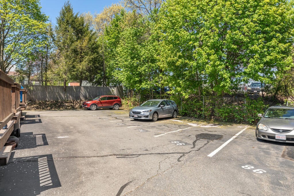 84 Lancaster Road, Unit 84 Dedham, MA 02026 - Photo 23 of 23 a car parked on the side of the road