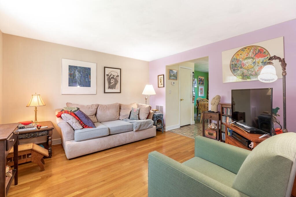 84 Lancaster Road, Unit 84 Dedham, MA 02026 - Photo 3 of 23 a living room with furniture and a flat screen tv