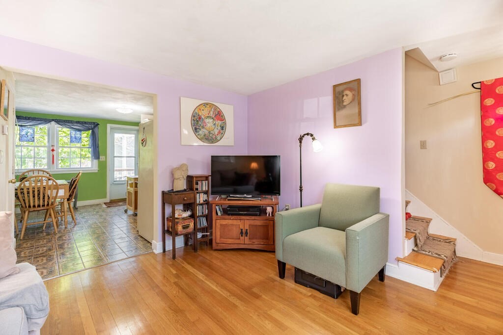 84 Lancaster Road, Unit 84 Dedham, MA 02026 - Photo 4 of 23 a living room with furniture and a flat screen tv