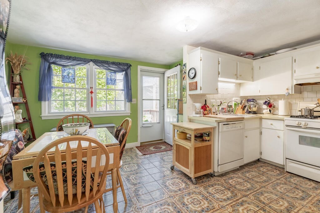 84 Lancaster Road, Unit 84 Dedham, MA 02026 - Photo 6 of 23 a kitchen with stainless steel appliances kitchen island granite countertop a stove a sink and a refrigerator