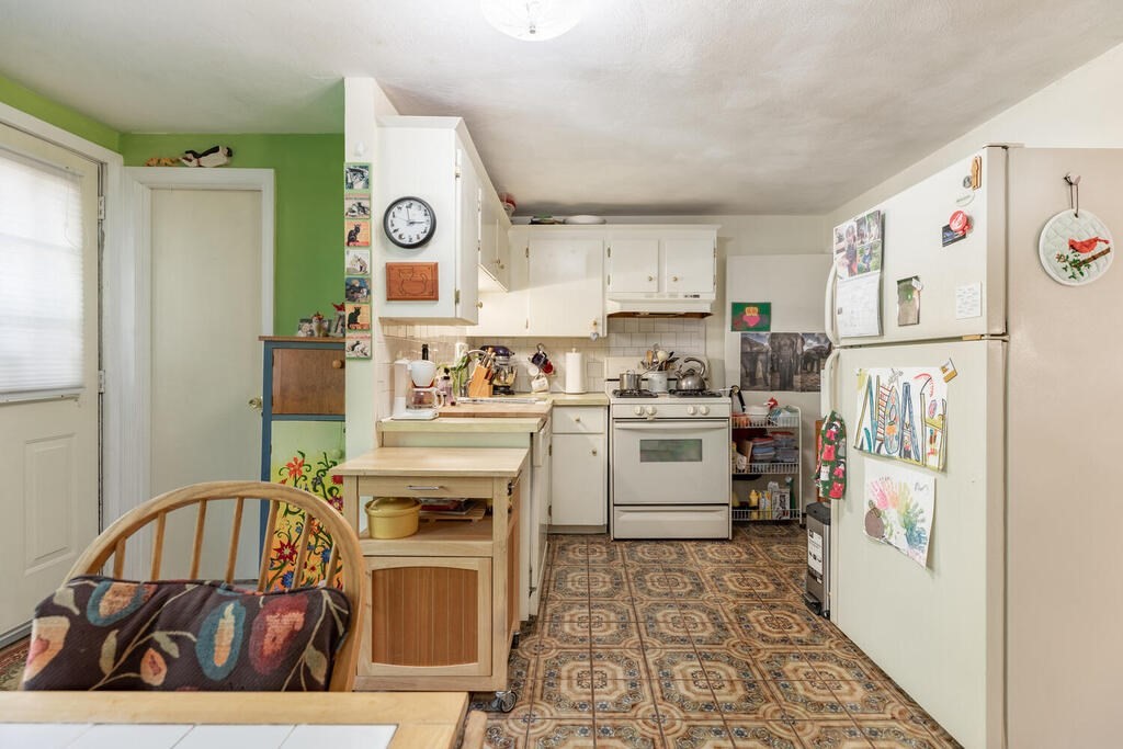84 Lancaster Road, Unit 84 Dedham, MA 02026 - Photo 7 of 23 a kitchen with a refrigerator and a stove top oven