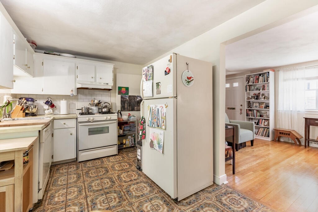 84 Lancaster Road, Unit 84 Dedham, MA 02026 - Photo 8 of 23 a kitchen with a refrigerator a stove and a sink