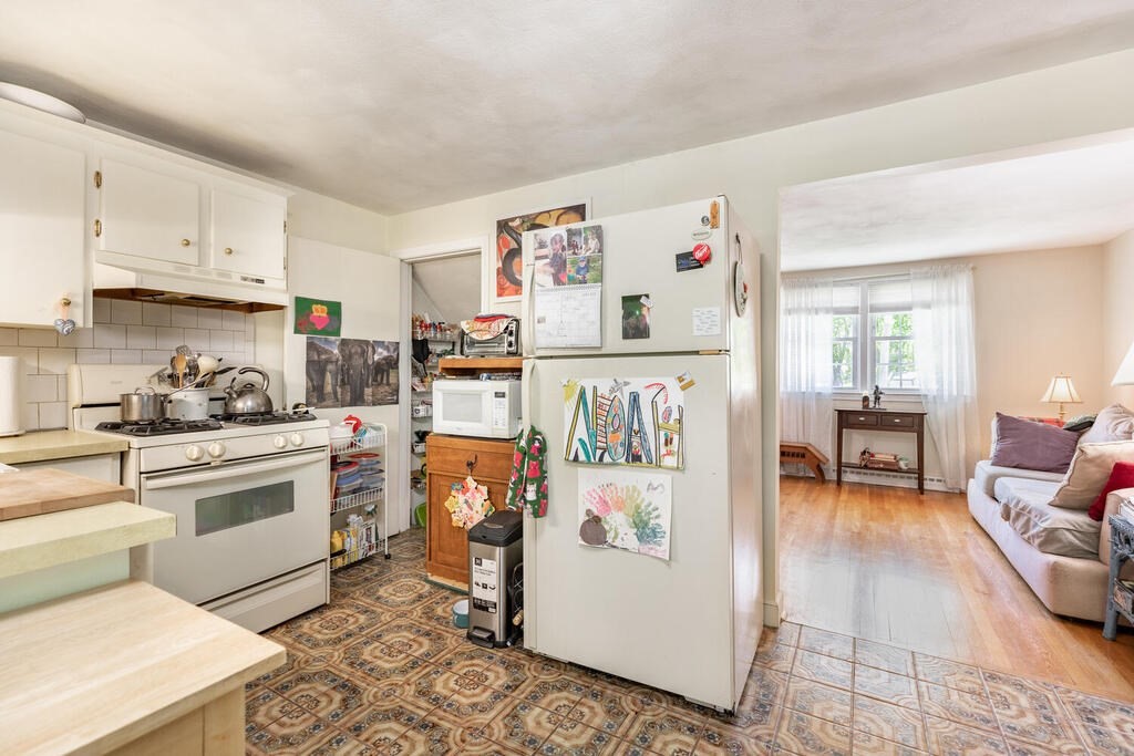 84 Lancaster Road, Unit 84 Dedham, MA 02026 - Photo 9 of 23 a kitchen with a white stove top oven and white cabinets