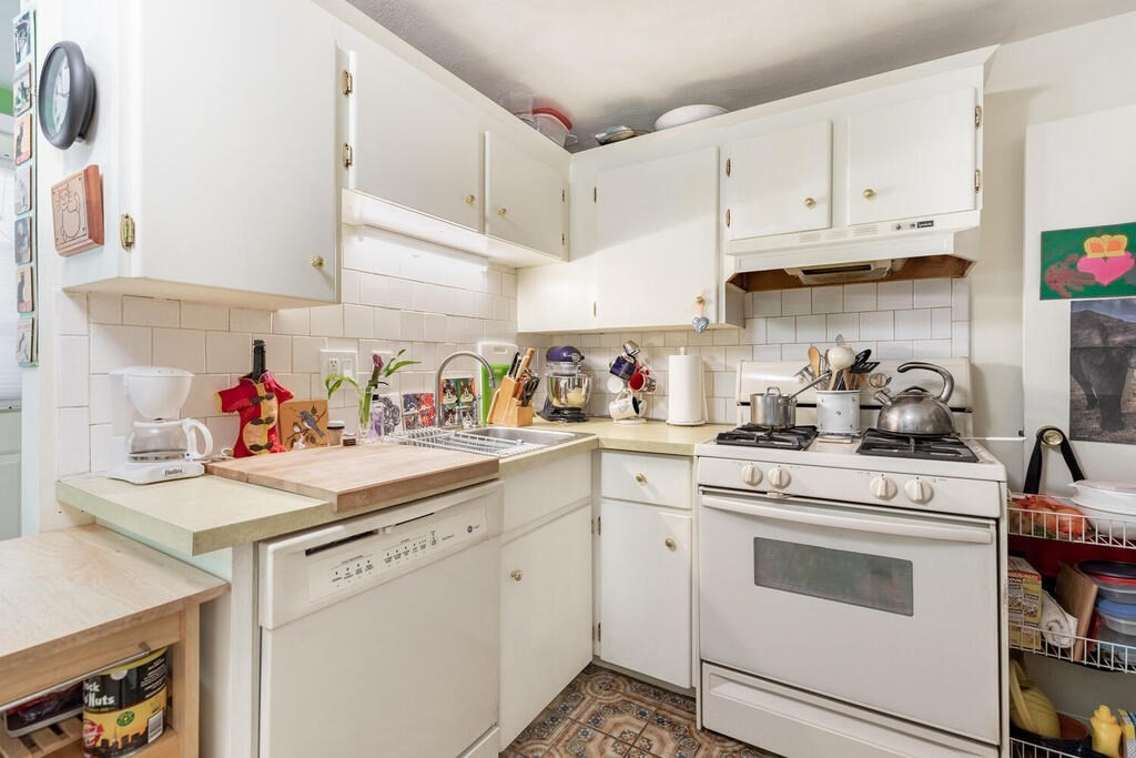84 Lancaster Road, Unit 84 Dedham, MA 02026 - Photo 10 of 23 a kitchen with cabinets appliances a sink and a counter top space