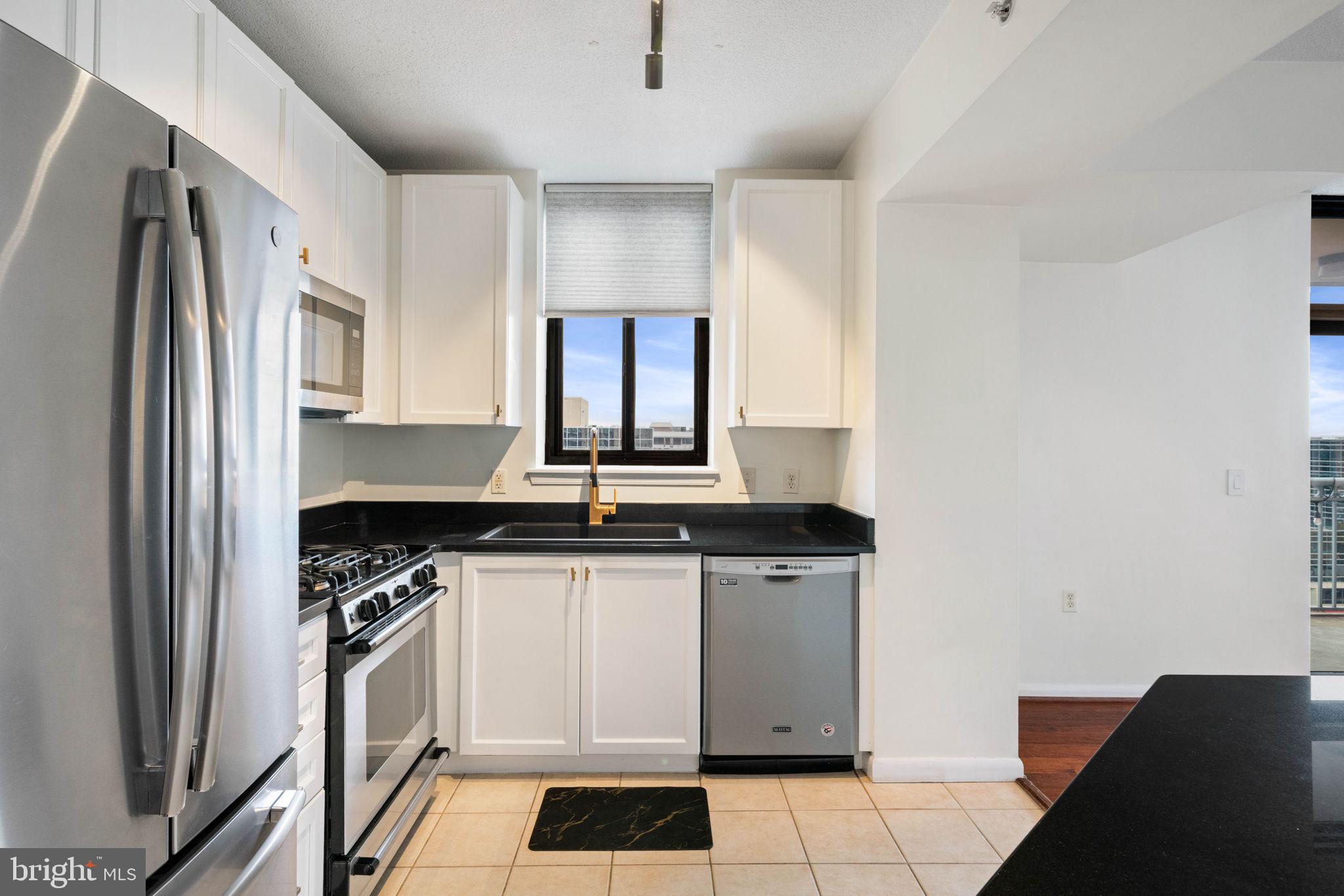 851 North Glebe Road, Unit 1011 Arlington, VA 22203 - Photo 11 of 41 a kitchen with stainless steel appliances a sink stove and refrigerator