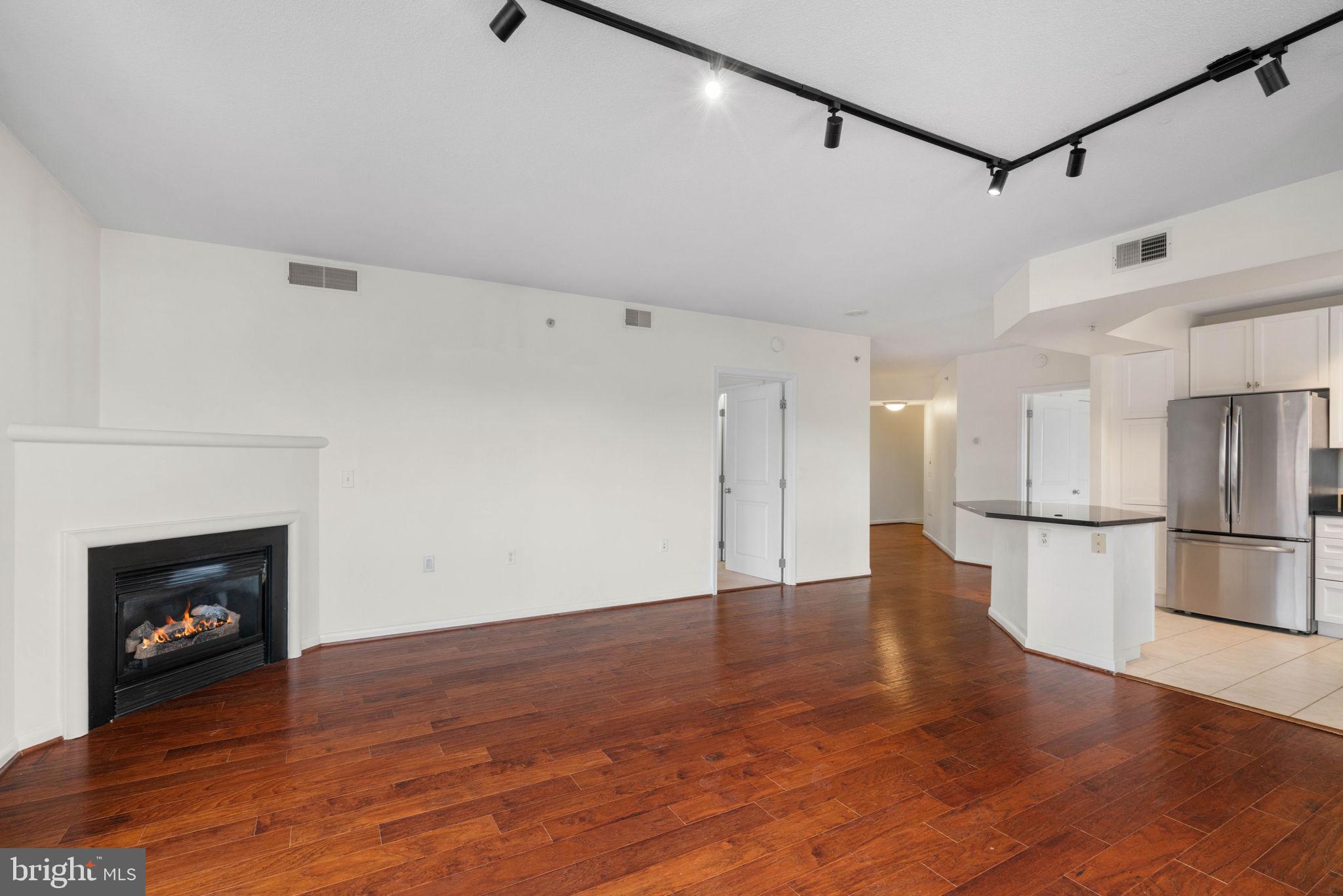 851 North Glebe Road, Unit 1011 Arlington, VA 22203 - Photo 14 of 41 a view of a hallway with a fireplace and wooden floor