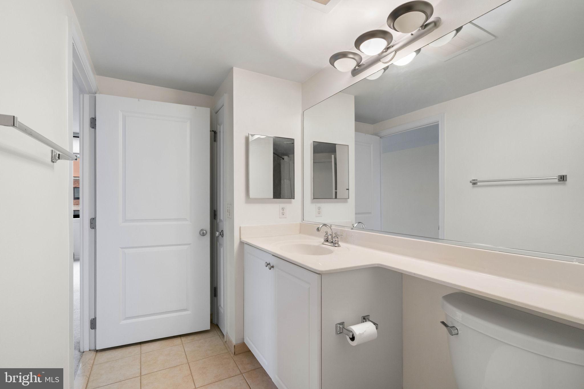 851 North Glebe Road, Unit 1011 Arlington, VA 22203 - Photo 24 of 41 a bathroom with a sink and mirror