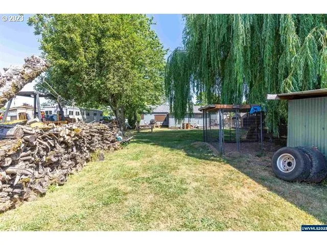 a view of a backyard with table and chairs and potted plants