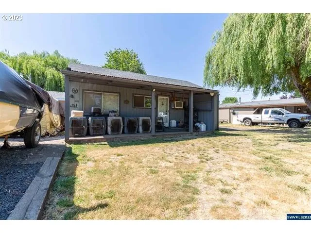 a view of a house with a yard and sitting area