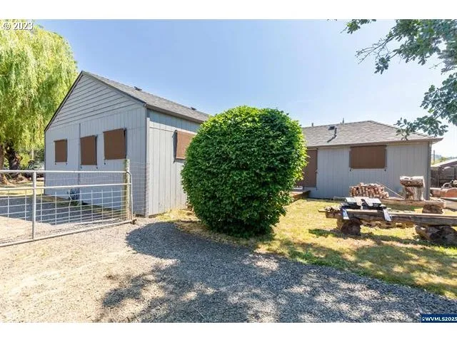 a view of a house with backyard porch and sitting area