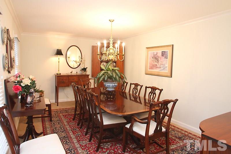 7913 Harps Mill Road Raleigh, NC 27615 - Photo 8 of 16 a view of a dining room with furniture and wooden floor