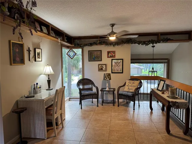 a kitchen with a table chairs refrigerator and microwave