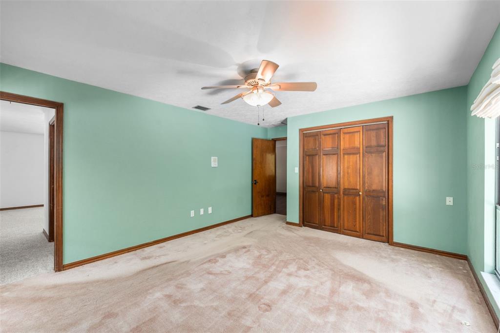 4703 Northwest 124th Street Gainesville, FL 32606 - Photo 30 of 55 an empty room with closet and a ceiling fan