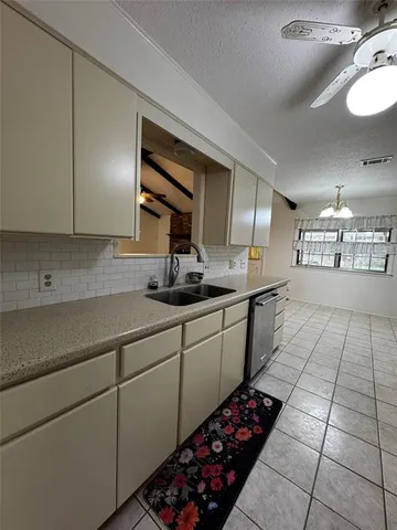 a kitchen with stainless steel appliances a sink stove and cabinets