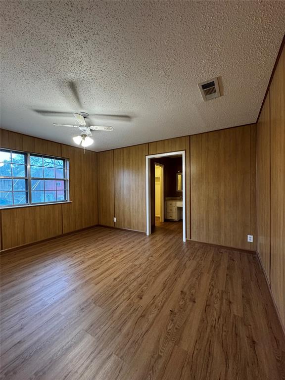 3205 Pin Oak Drive Temple, TX 76502 - Photo 14 of 30 a view of an empty room with wooden floor and windows