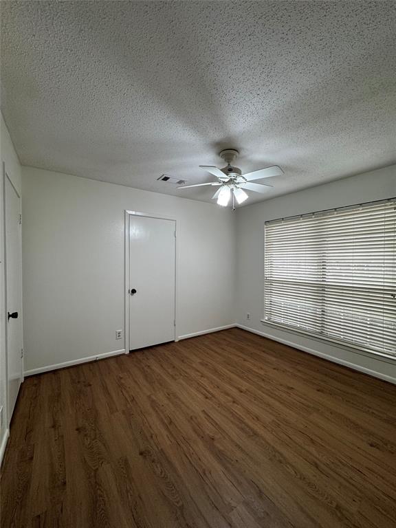 3205 Pin Oak Drive Temple, TX 76502 - Photo 23 of 30 an empty room with wooden floor fan and windows