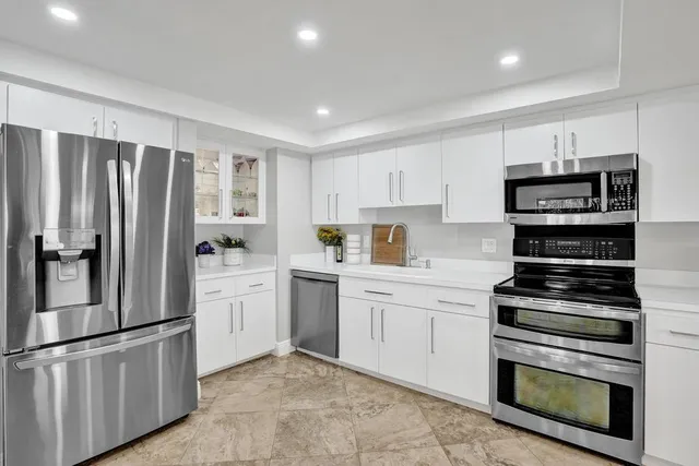 a kitchen with stove cabinets and refrigerator