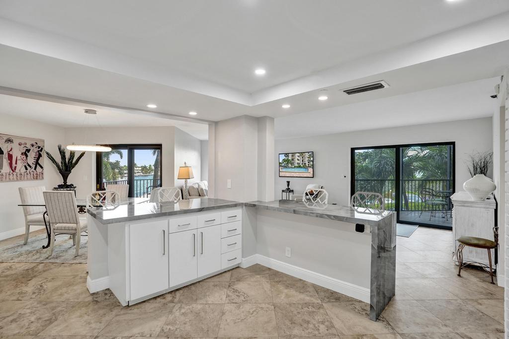 501 North Riverside Drive, Unit 203 Pompano Beach, FL 33062 - Photo 17 of 63 a kitchen with counter top space cabinets and living room