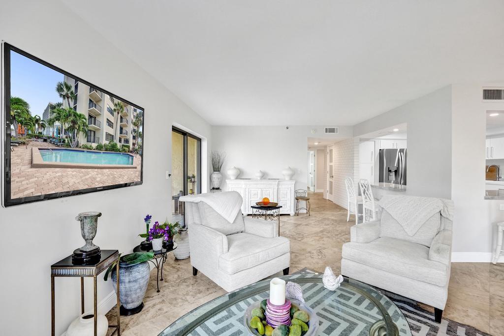 501 North Riverside Drive, Unit 203 Pompano Beach, FL 33062 - Photo 25 of 63 a living room with furniture and a flat screen tv