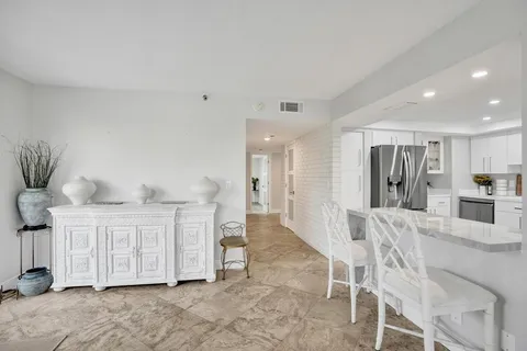 a bedroom with a bed and a large mirror